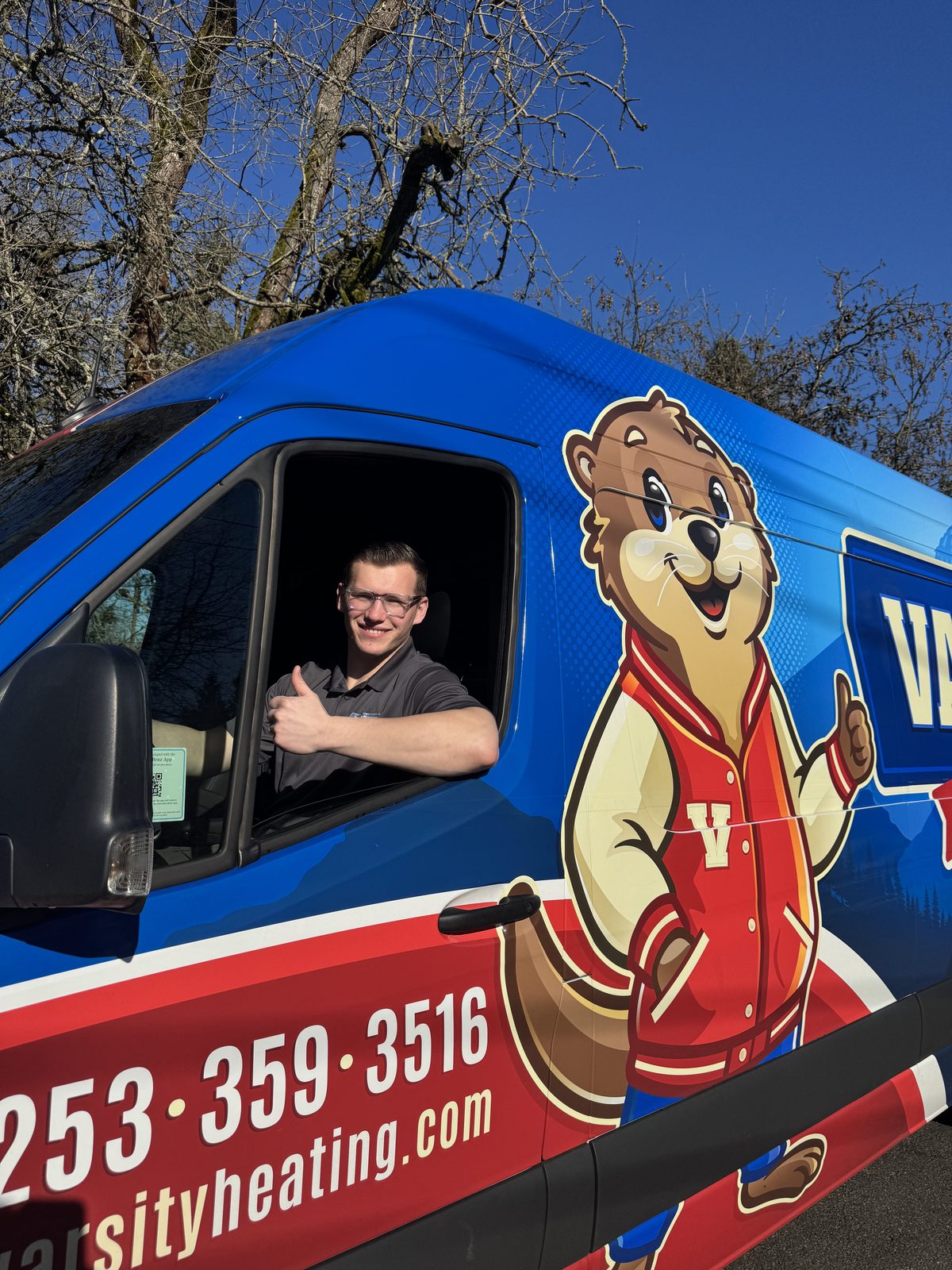 Vlad, Varsity's co-owner, giving a thumbs up from the driver's seat of a Varsity van